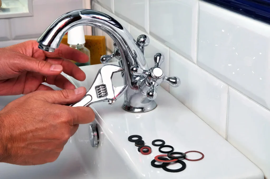 Plumber performing maintenance on a bathroom faucet in Winter Springs