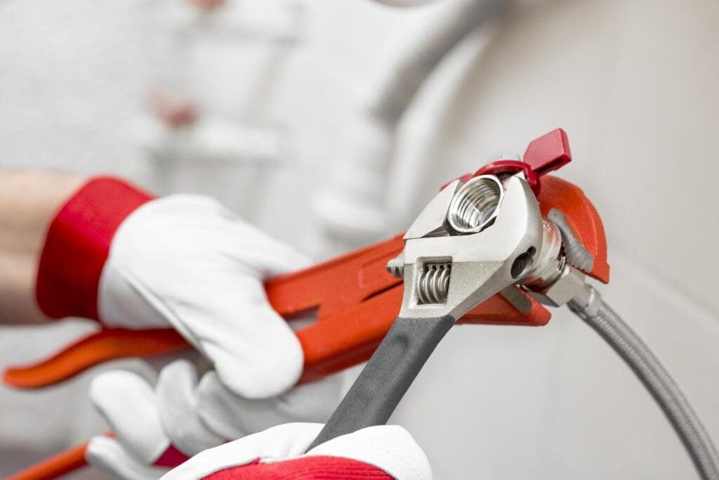Plumber holding pipe wrenches for an emergency repair in Winter Springs