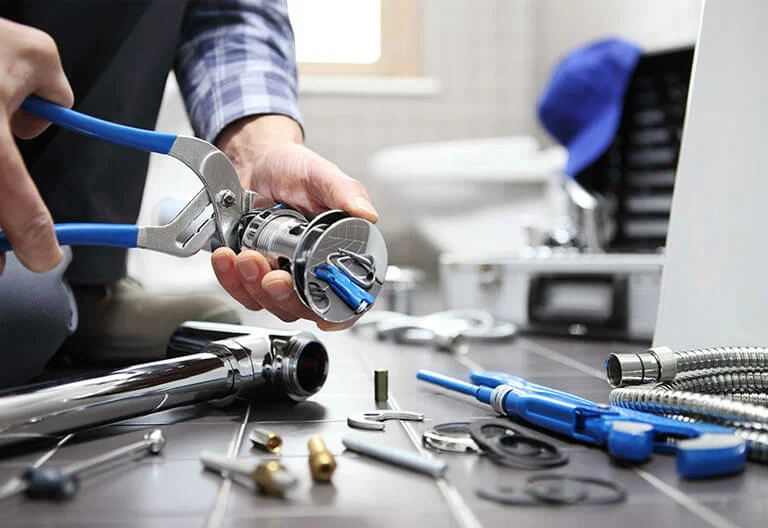 Technician repairing a plumbing fixture with professional tools in Winter Springs