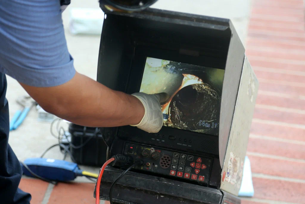 Technician viewing a drain inspection camera in Winter Springs