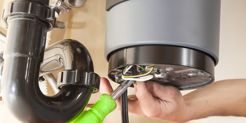 Technician repairing the heating element of a water heater in Winter Springs