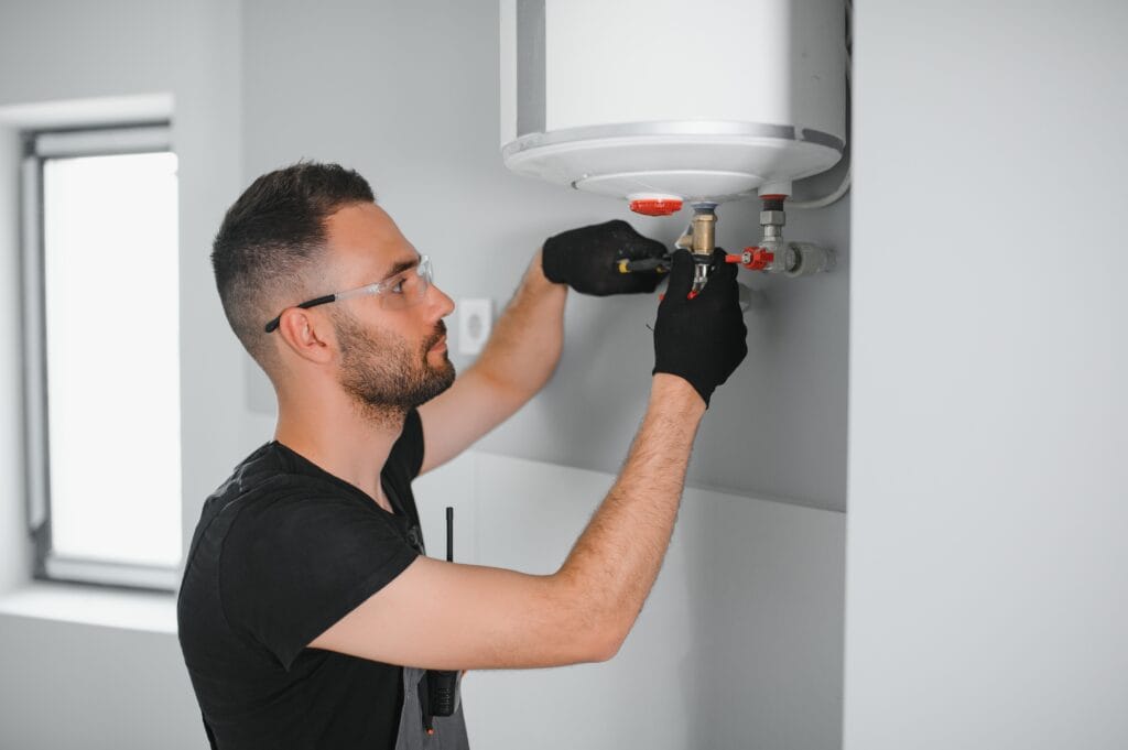 Technician performing water heater maintenance in Winter Springs