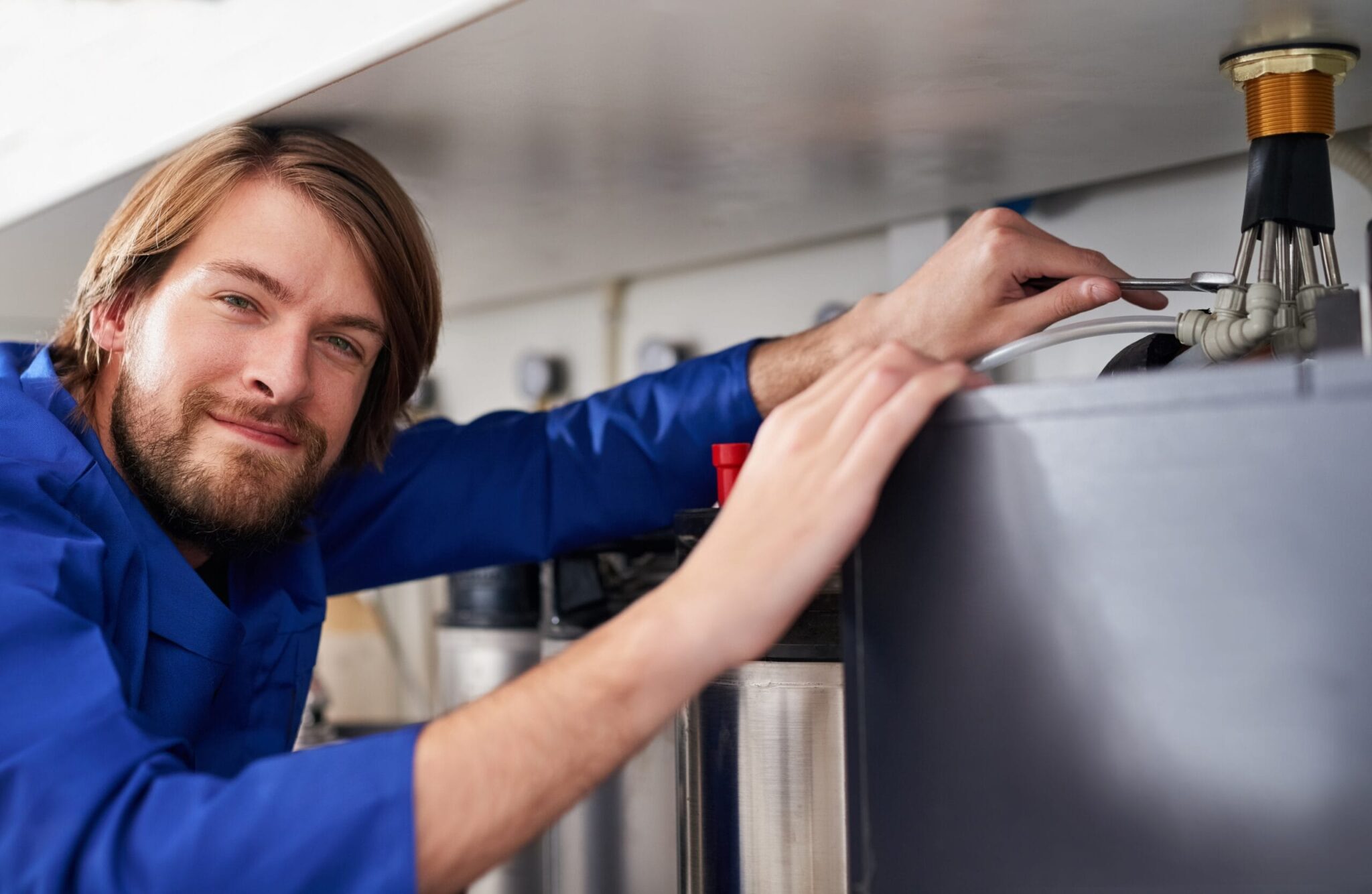 Technician servicing a residential water heater tank in Winter Springs