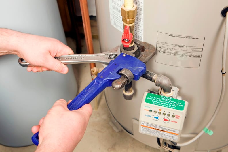 Plumber repairing a water heater valve in Winter Springs